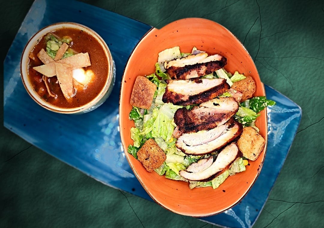 small Mexican Caesar with blackened chicken and a cup of chicken tortilla soup